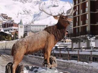 Discover the charm of this property, featuring a stunning wooden elk sculpture as a focal point.