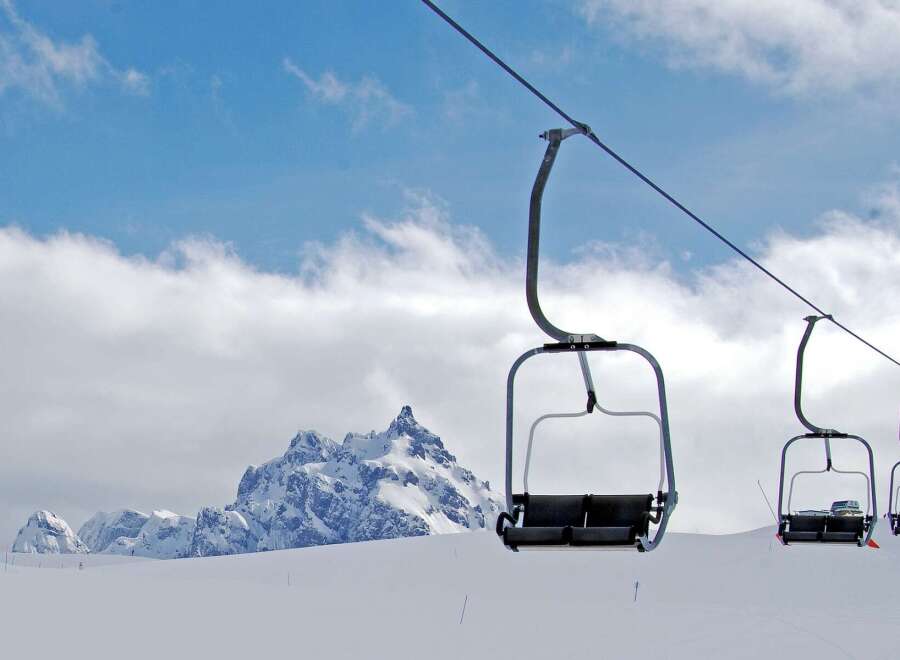 Experience the thrill of the slopes with this stunning image of a ski lift.