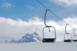 Experience the thrill of the slopes with this stunning image of a ski lift.