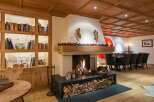 Experience the warmth of this stunning chalet, featuring a cozy fireplace and a beautifully crafted wooden ceiling.