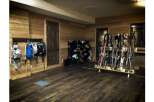 This cozy ski storage room features beautiful wood paneling and a warm, inviting atmosphere.
