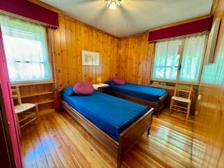 Cozy bedroom with two twin beds, perfect for a relaxing getaway.