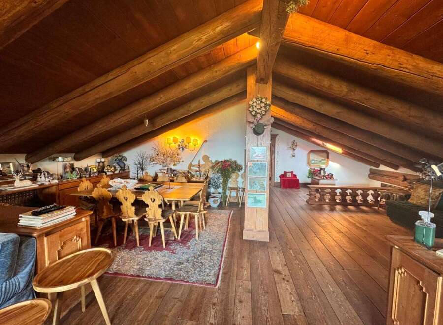 Step into a rustic haven with this stunning property, featuring a spacious interior with exposed wooden beams and a warm, inviting atmosphere.
