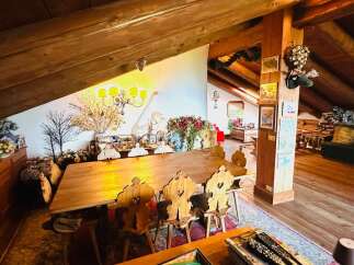 This charming property boasts a unique, rustic interior with exposed wooden beams and a cozy atmosphere.