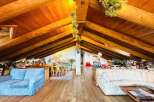 Discover the charm of this unique property featuring a stunning wooden beamed ceiling and a cozy living space.