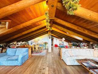 Discover the charm of this unique property featuring a stunning wooden beamed ceiling and a cozy living space.