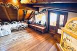 Step into a cozy and inviting living space with stunning wooden floors and a unique architectural design.