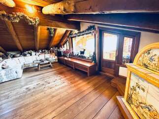 Step into a cozy and inviting living space with stunning wooden floors and a unique architectural design.