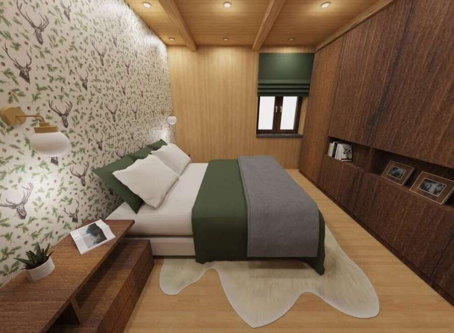 This cozy bedroom features a unique deer-themed wallpaper, creating a rustic and inviting atmosphere.