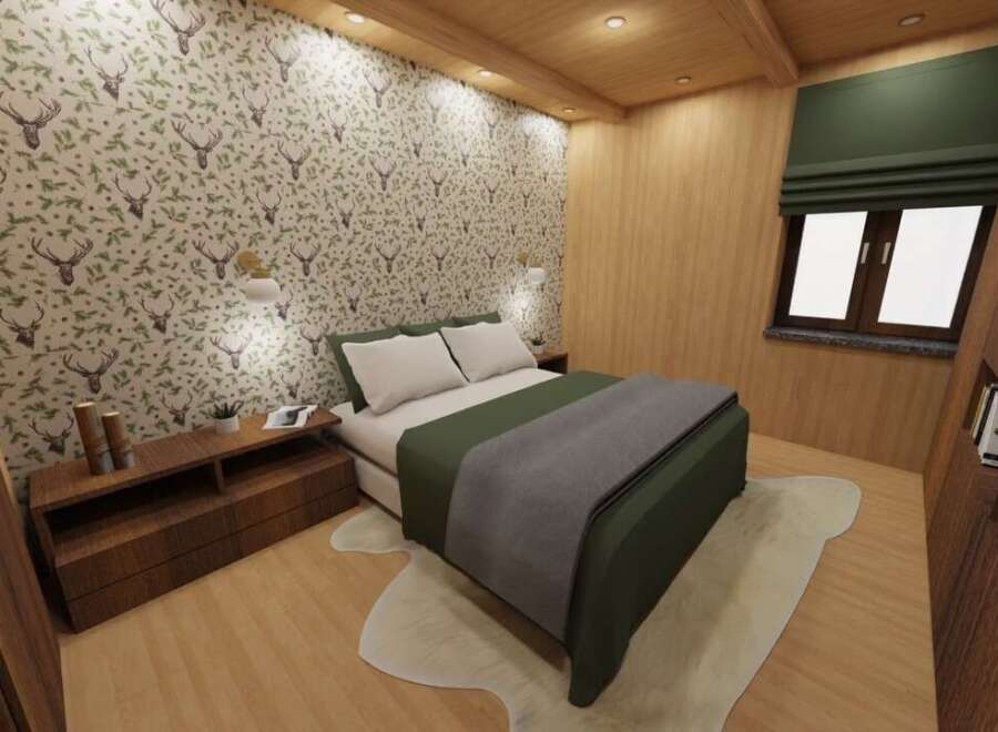 This cozy bedroom features a unique deer-themed wallpaper, creating a rustic and inviting atmosphere.