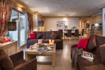 This stunning apartment boasts a spacious living area with comfortable sofas, a large dining table, and a fully equipped kitchen.