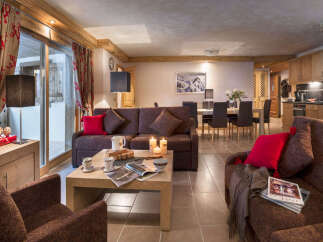 This stunning apartment boasts a spacious living area with comfortable sofas, a large dining table, and a fully equipped kitchen.