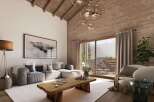 This stunning chalet boasts a spacious living area with floor-to-ceiling windows offering breathtaking mountain views.