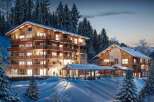 Luxury chalet apartments nestled in a snowy mountain setting.