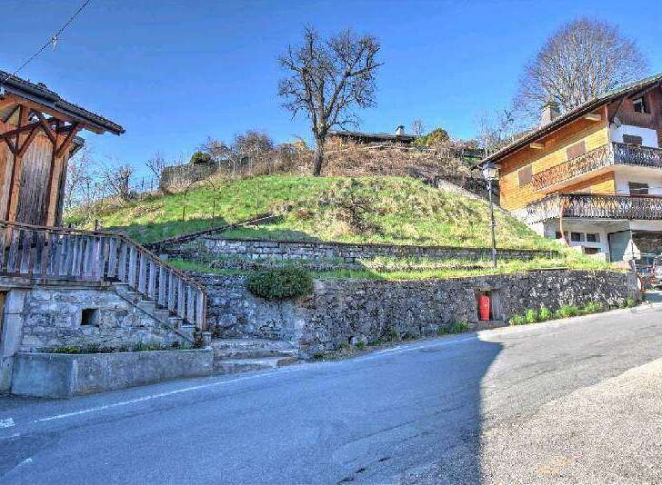Mountain view lot with stone retaining wall and steps.