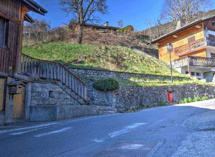 Charming wooden chalet nestled on a hillside, offering stunning views.