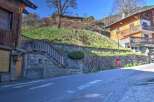 Charming wooden chalet nestled on a hillside, offering stunning views.