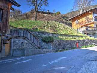 Charming wooden chalet nestled on a hillside, offering stunning views.
