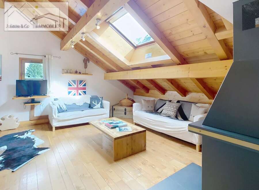 Discover the charm of this cozy attic retreat, featuring a stunning wooden ceiling and ample natural light from the skylight.