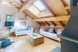 Discover the charm of this cozy attic retreat, featuring a stunning wooden ceiling and ample natural light from the skylight.