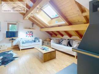 Discover the charm of this cozy attic retreat, featuring a stunning wooden ceiling and ample natural light from the skylight.