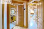 Discover the charm of this inviting property, featuring a warm wooden interior and a well-lit hallway.