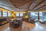 This stunning chalet boasts a spacious open-plan living area with a beautiful wooden ceiling and hardwood floors.