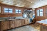 This stunning kitchen boasts a rustic-chic design with exposed wooden beams and a granite countertop.