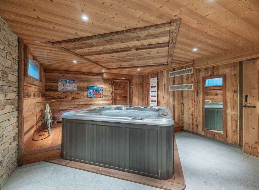 Relax and rejuvenate in this luxurious hot tub nestled within a stunning, wood-paneled room.