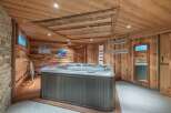 Relax and rejuvenate in this luxurious hot tub nestled within a stunning, wood-paneled room.