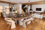 Stunning open-plan living space featuring a modern kitchen with marble island, a cozy living area with a fireplace, and a spacious dining area.