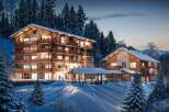 Luxury chalet apartments nestled in a snowy mountainside setting.