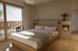 Wake up to breathtaking mountain views from this cozy bedroom.