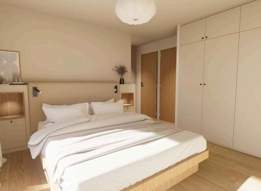 This stunning bedroom boasts a minimalist design with built-in wardrobes and a light oak wood platform bed.