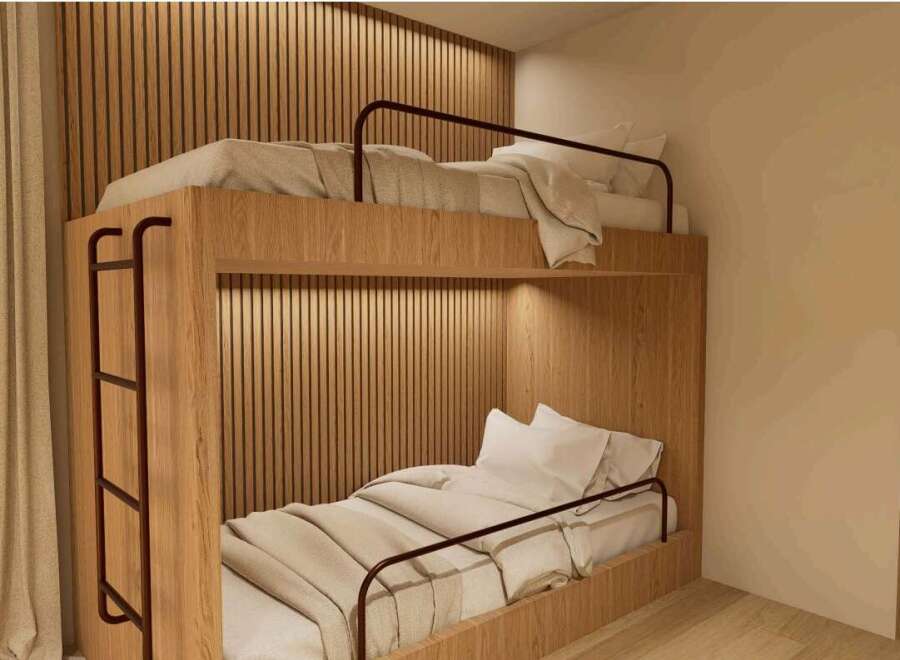 Cozy bunk bed in a modern room with wooden walls and neutral tones.