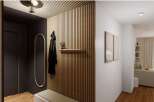 Stylish apartment hallway with wood slat wall, built-in bench, and modern lighting.