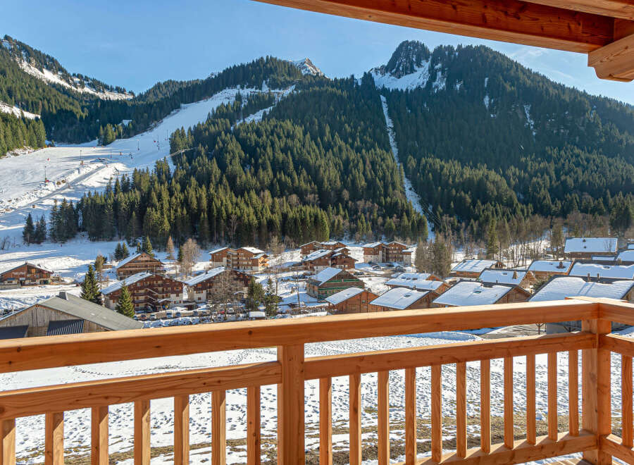 This stunning property boasts breathtaking views of snow-capped mountains and a charming village from its private balcony.