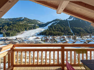 This stunning chalet boasts breathtaking views of the snowy mountains and ski slopes.
