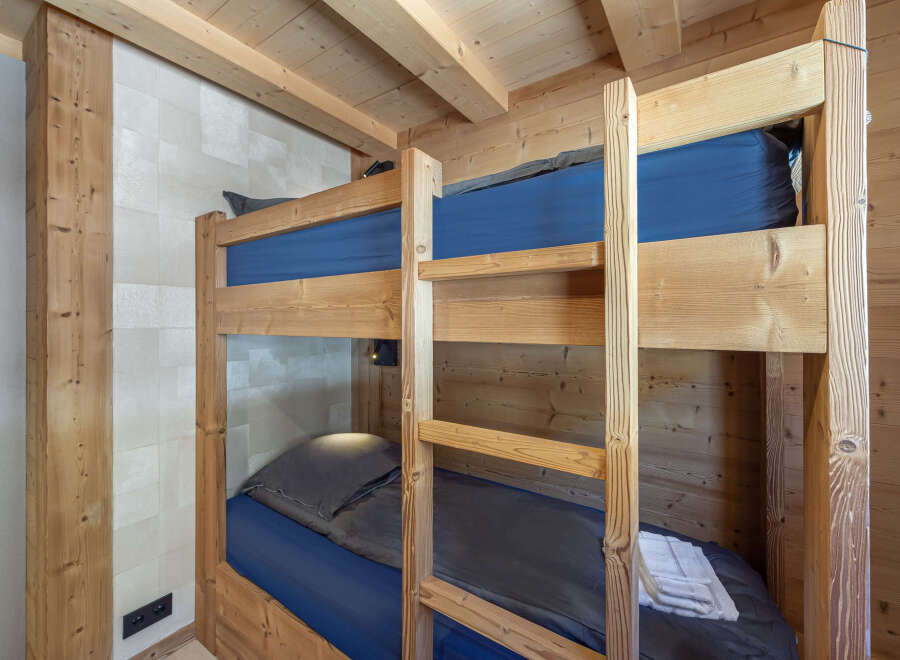 Cozy chalet with rustic bunk beds, perfect for a family getaway.