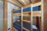 Cozy chalet with rustic bunk beds, perfect for a family getaway.