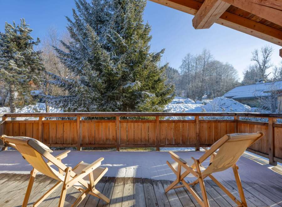 Enjoy breathtaking mountain views from this cozy balcony.
