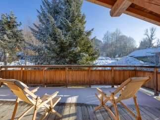 Enjoy breathtaking mountain views from this cozy balcony.