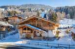 Experience the ultimate winter getaway in this stunning chalet nestled in a snowy landscape.