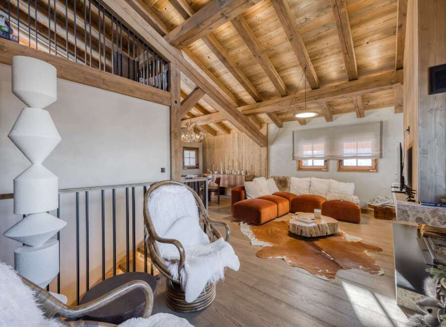 Experience rustic luxury in this stunning chalet, featuring exposed wooden beams and a cozy ambiance.