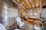 Experience rustic luxury in this stunning chalet, featuring exposed wooden beams and a cozy ambiance.