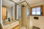 This luxurious bathroom features a sleek, modern design with a spacious walk-in shower and elegant fixtures.