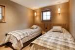 Cozy bedroom with two twin beds, perfect for a relaxing getaway.