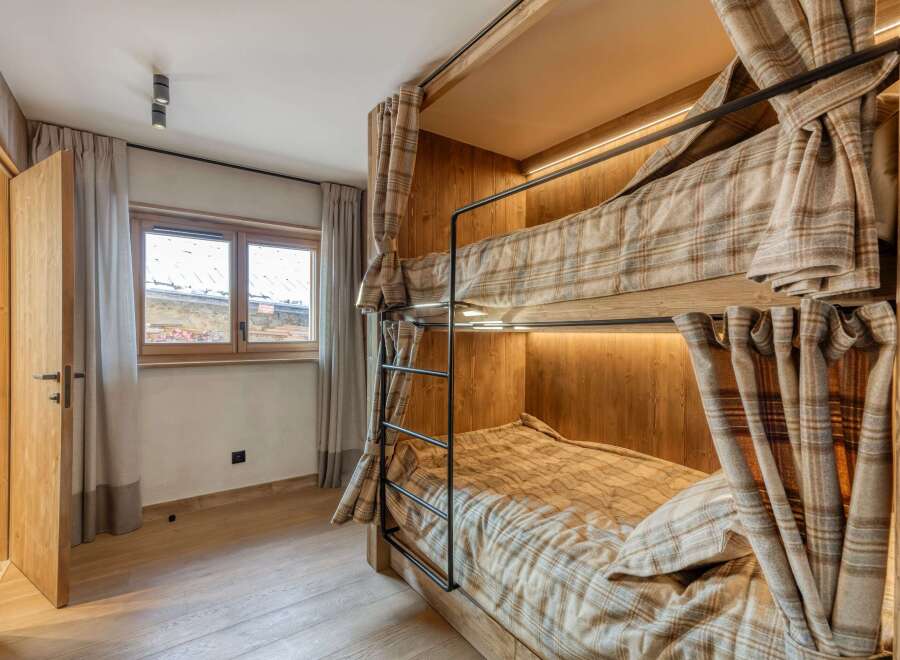 Cozy bunk beds with plaid bedding offer a comfortable sleeping arrangement.