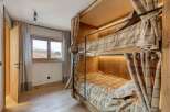 Cozy bunk beds with plaid bedding offer a comfortable sleeping arrangement.