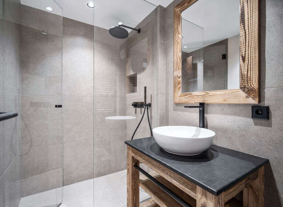 Modern bathroom with a walk-in shower and a rustic wooden vanity.